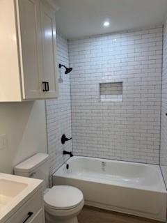 320 Ralph Street, Unit D White Settlement, TX 76108 - Photo 5 of 7 a bathroom with a toilet a sink and bathtub