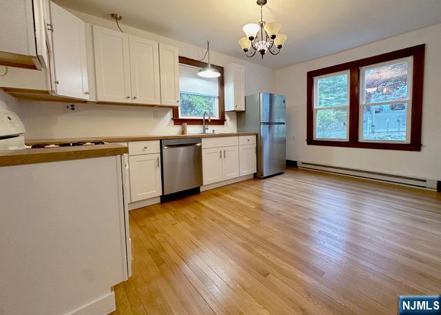 1156 High Mountain Road North Haledon, NJ 07508 - Photo 2 of 14 a kitchen with stainless steel appliances granite countertop white cabinets a stove top oven a sink and dishwasher