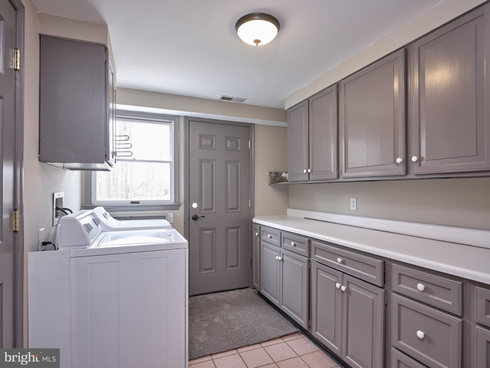 1296 Durham Road Buckingham, PA 18938 - Photo 6 of 13 a utility room with cabinets washer and dryer