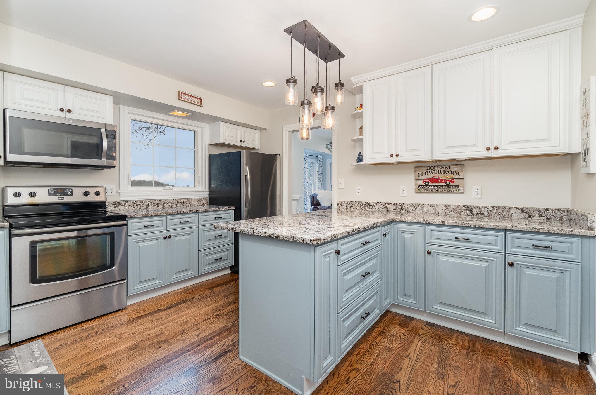 35 North Tannery Road Westminster, MD 21157 - Photo 6 of 47 a kitchen with granite countertop a sink cabinets stainless steel appliances and wooden floor