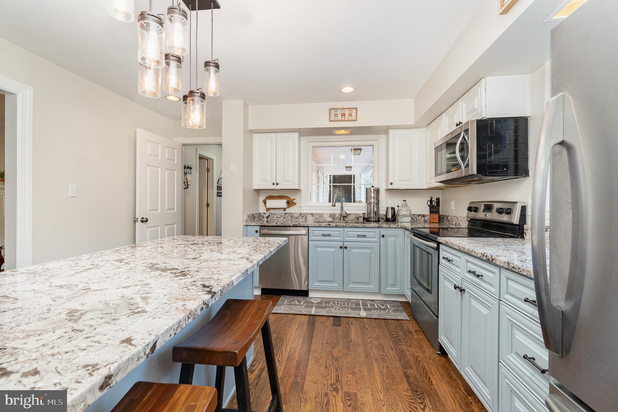 35 North Tannery Road Westminster, MD 21157 - Photo 8 of 47 a kitchen with stainless steel appliances kitchen island granite countertop a sink refrigerator dining table and chairs