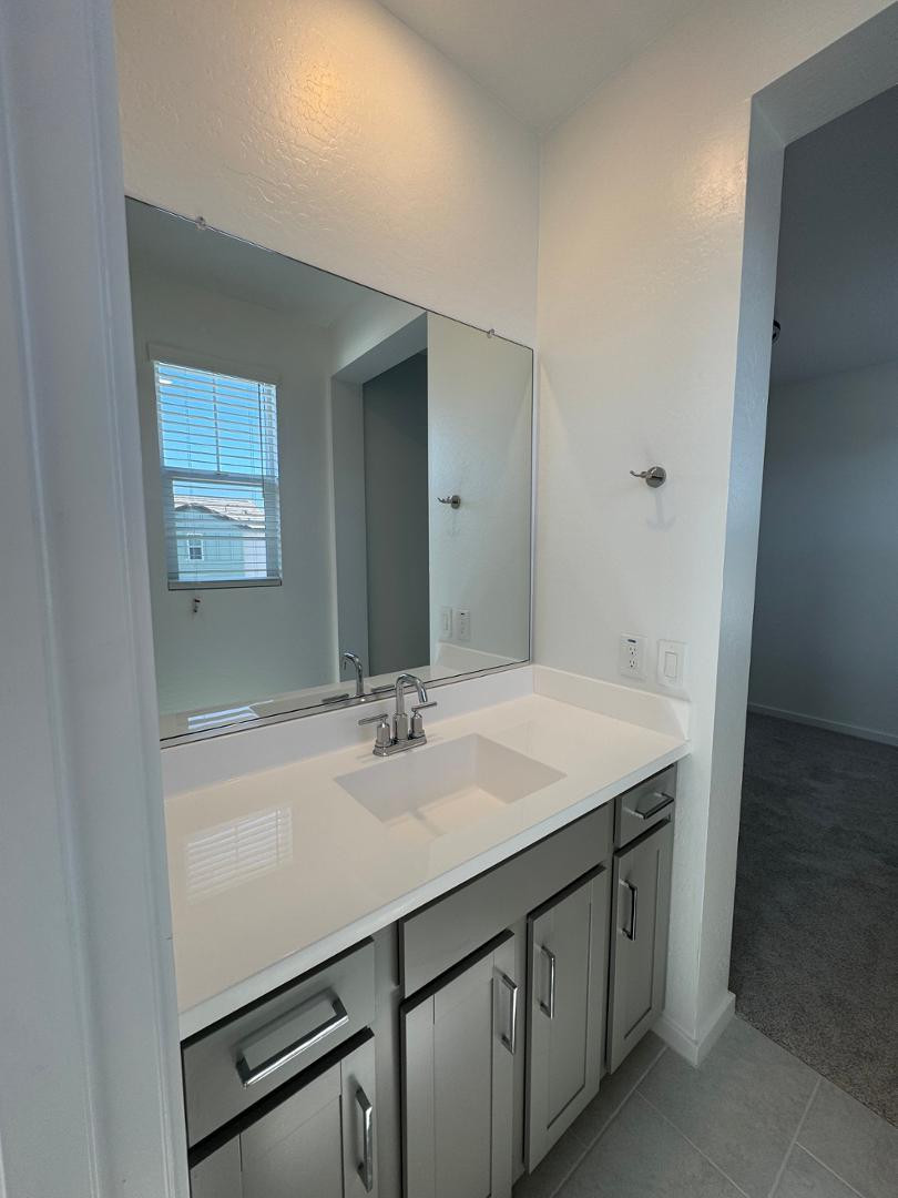 2442 West Maximo Way Phoenix, AZ 85085 - Photo 11 of 16 a bathroom with a sink and a mirror