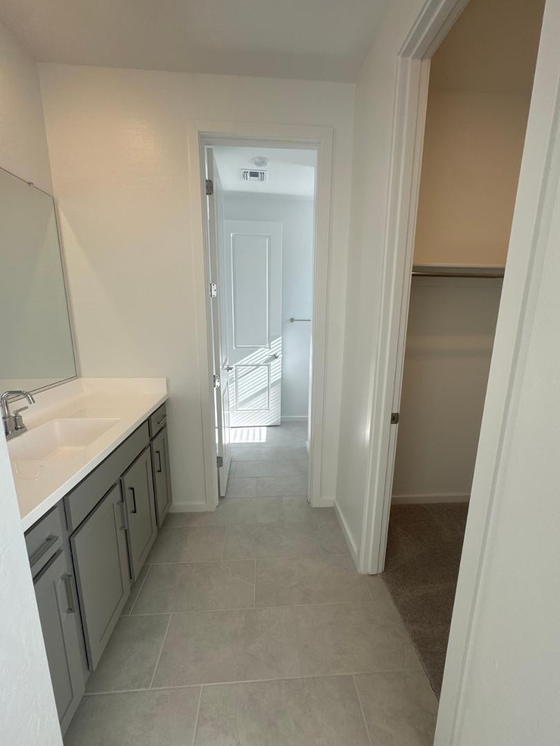 2442 West Maximo Way Phoenix, AZ 85085 - Photo 12 of 16 a view of a bathroom from a hallway
