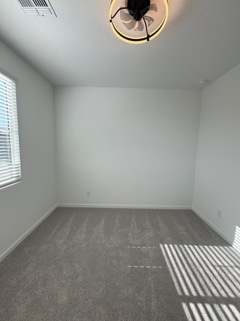 2442 West Maximo Way Phoenix, AZ 85085 - Photo 13 of 16 an empty room with a empty space and windows