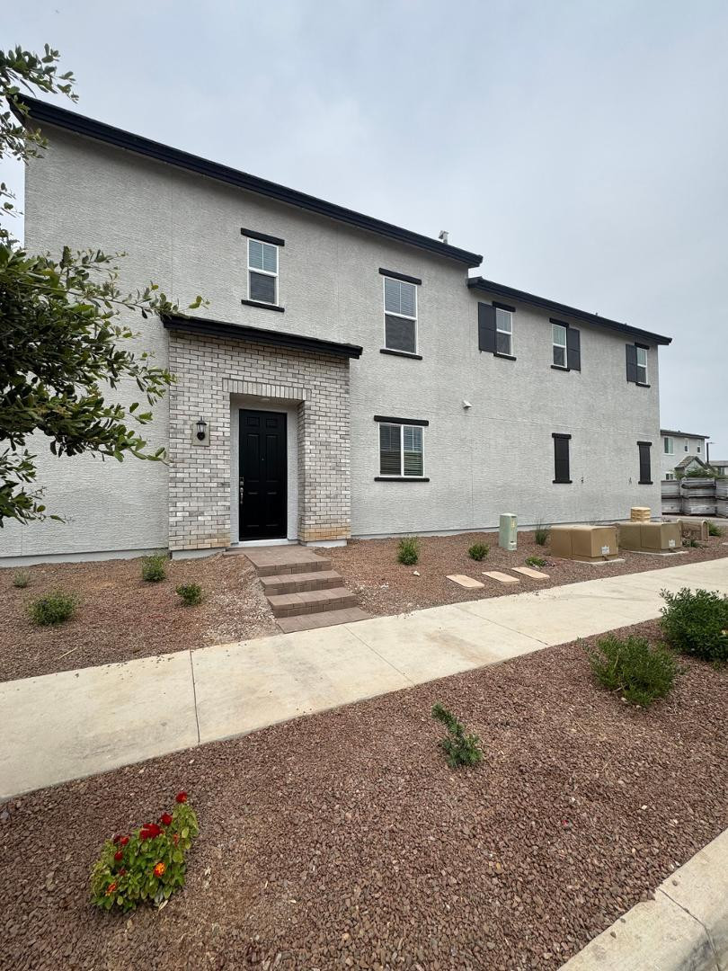 2442 West Maximo Way Phoenix, AZ 85085 - Photo 2 of 16 a view of a house with backyard and bushes