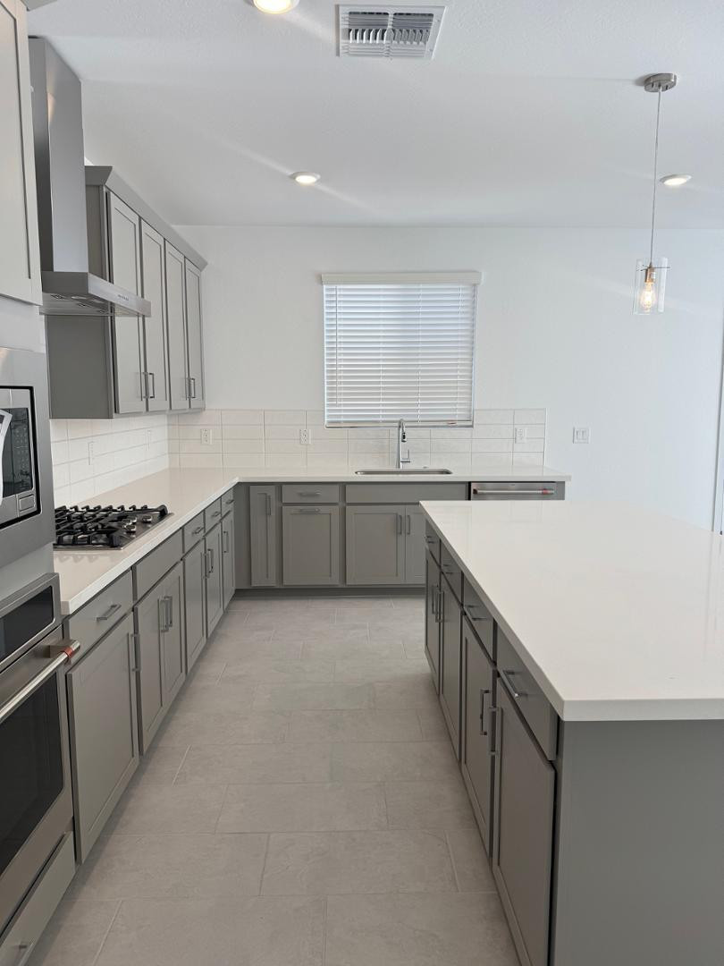 2442 West Maximo Way Phoenix, AZ 85085 - Photo 4 of 16 a large kitchen with a stove and cabinets
