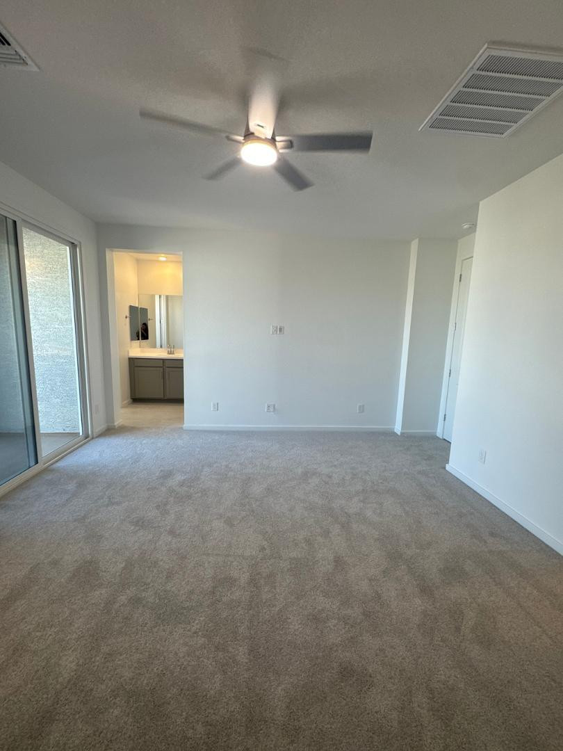 2442 West Maximo Way Phoenix, AZ 85085 - Photo 8 of 16 a view of a livingroom with an empty space and a ceiling fan