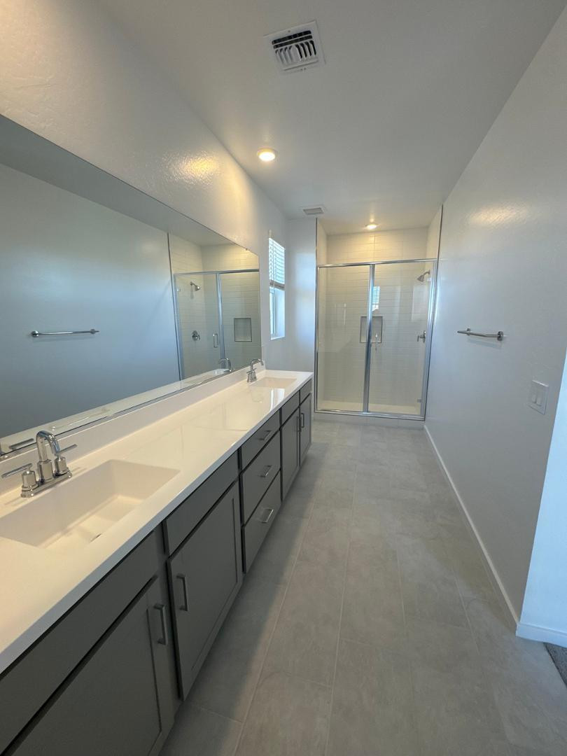 2442 West Maximo Way Phoenix, AZ 85085 - Photo 9 of 16 a spacious bathroom with a double vanity sink mirror and double