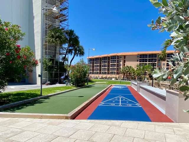 a view of swimming pool with a yard and potted plants