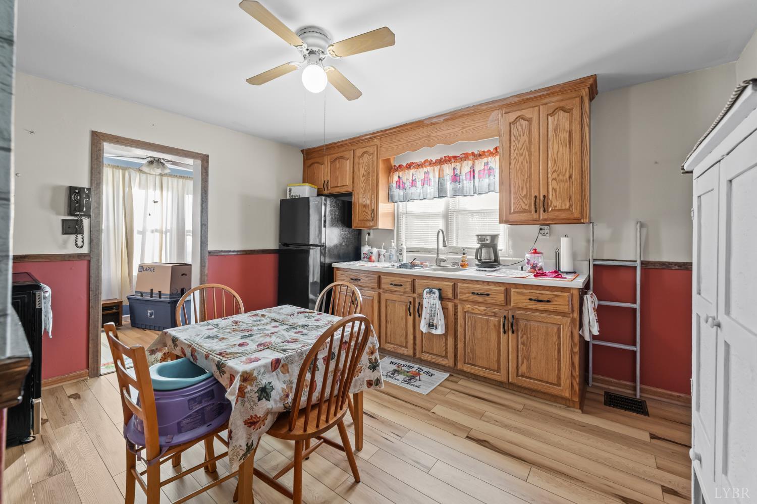 3169 Centerville Road Bedford, VA 24523 - Photo 10 of 25 a kitchen with a dining table chairs and refrigerator