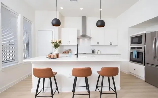 a kitchen with stainless steel appliances granite countertop counter space a sink and a stove