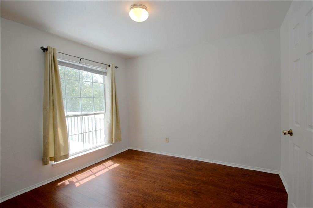 559 Raintree Circle Coppell, TX 75019 - Photo 11 of 18 a view of an empty room with wooden floor and a window