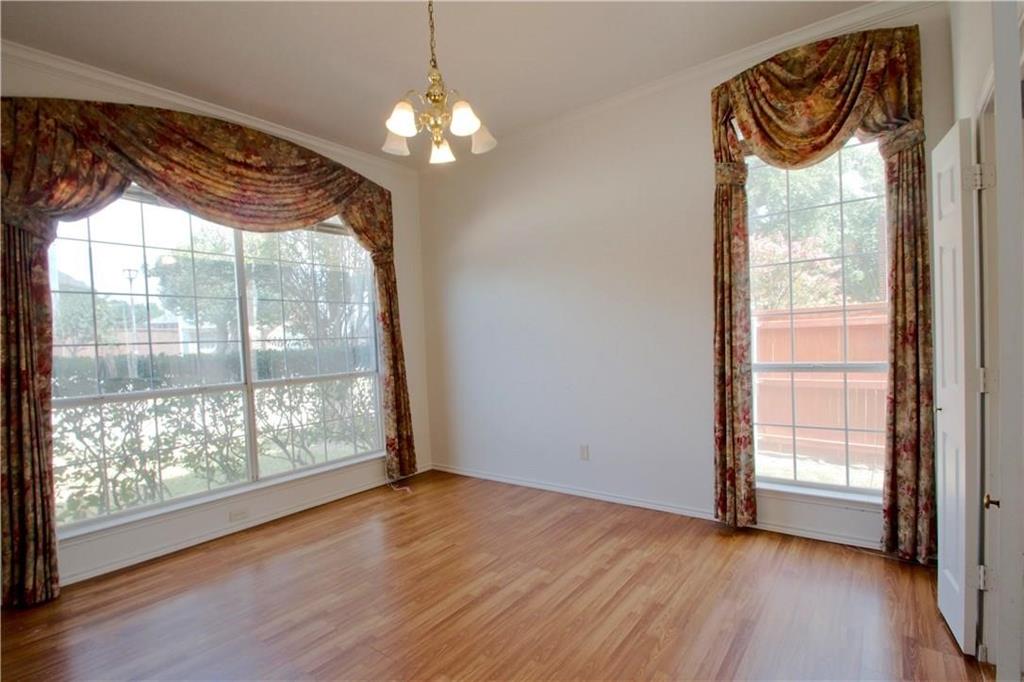 559 Raintree Circle Coppell, TX 75019 - Photo 17 of 18 an empty room with wooden floor and windows