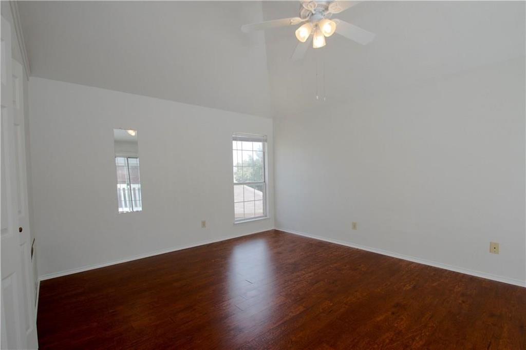 559 Raintree Circle Coppell, TX 75019 - Photo 3 of 18 an empty room with wooden floor and windows
