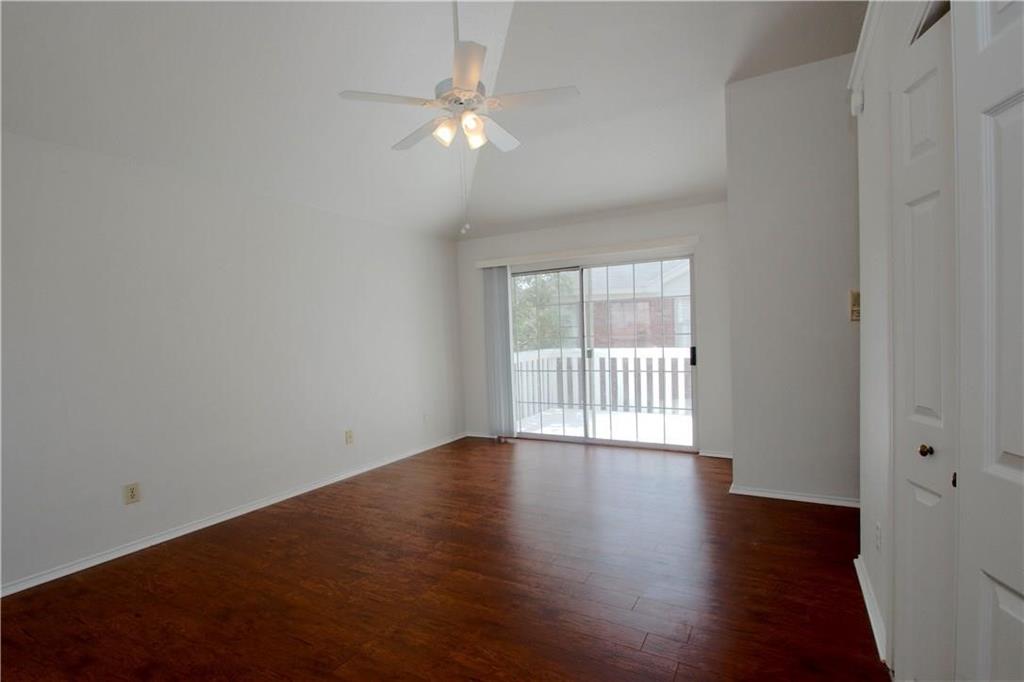 559 Raintree Circle Coppell, TX 75019 - Photo 4 of 18 a view of an empty room with wooden floor and a window
