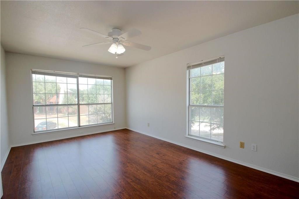 559 Raintree Circle Coppell, TX 75019 - Photo 8 of 18 a view of an empty room with wooden floor and a window
