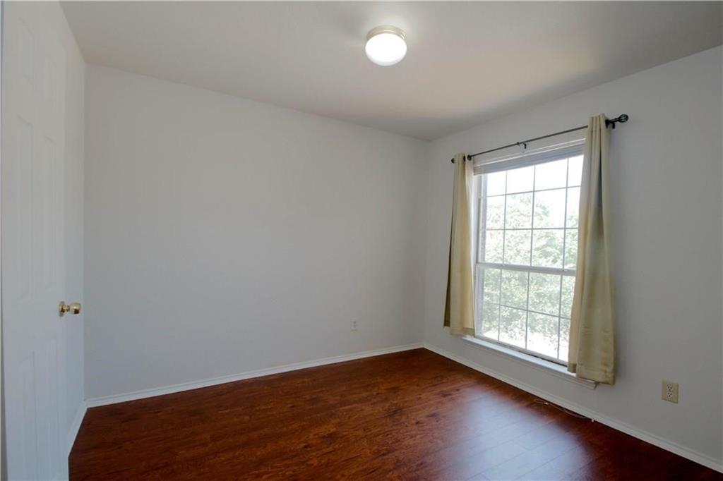 559 Raintree Circle Coppell, TX 75019 - Photo 10 of 18 an empty room with wooden floor and windows