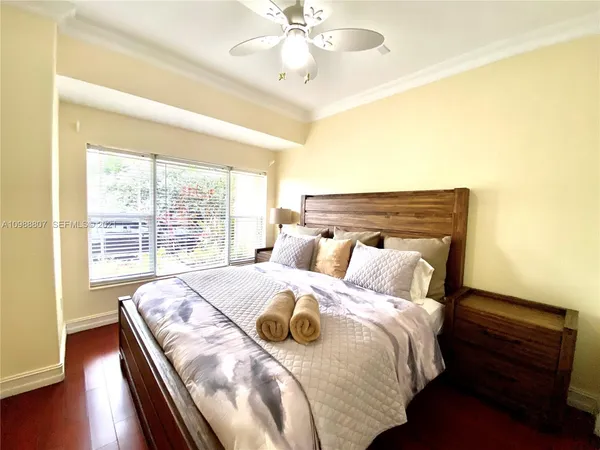 a bed sitting in a bedroom next to a window