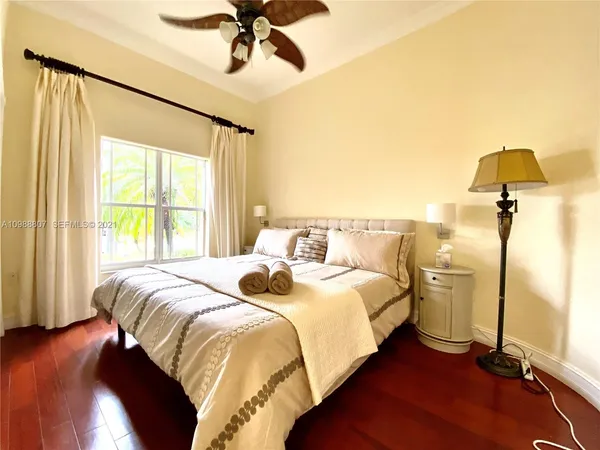 a bedroom with a bed and a chandelier