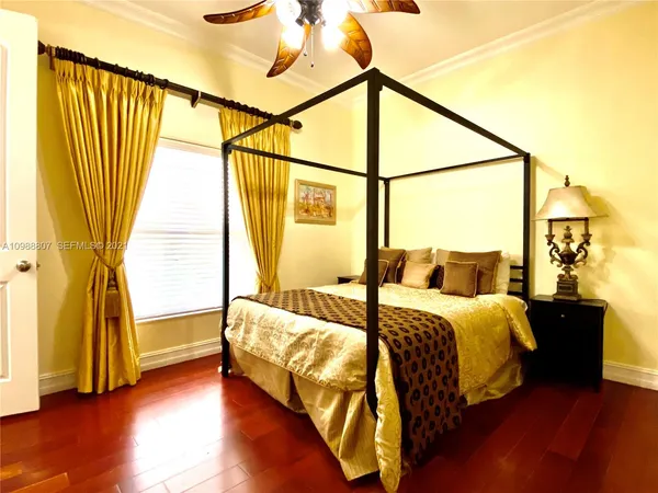 a bed sitting in a bedroom next to a window