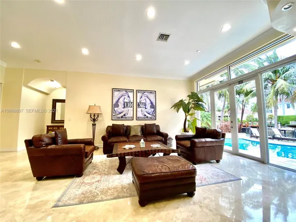 a living room with furniture gym equipment and a large window