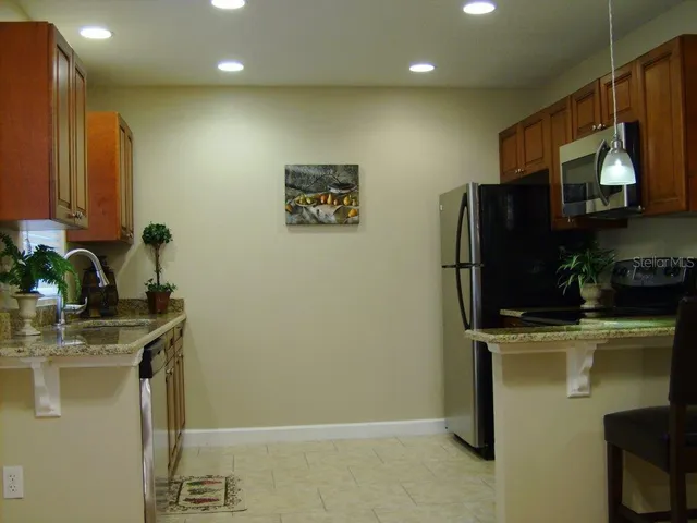 a kitchen with stainless steel appliances a refrigerator and a sink