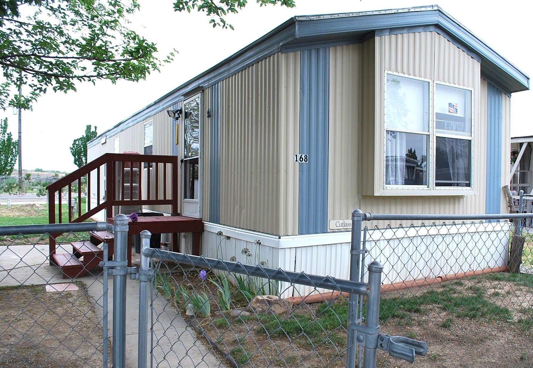 424 32 Road, Unit 168 Clifton, CO 81520 - Photo 1 of 17 a view of a house with a small yard and wooden fence