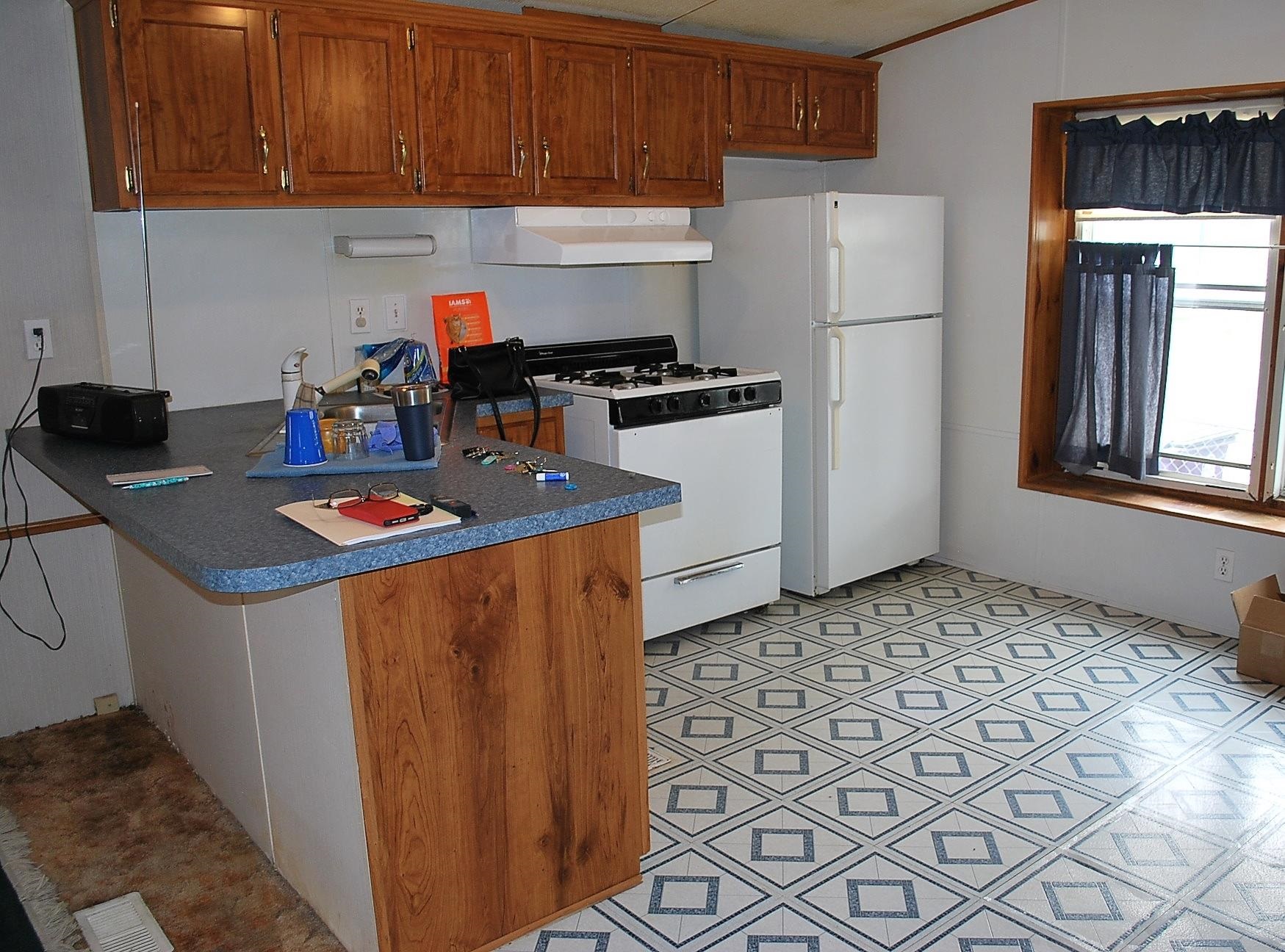 424 32 Road, Unit 168 Clifton, CO 81520 - Photo 3 of 17 a kitchen with granite countertop a refrigerator a stove a sink and white cabinets