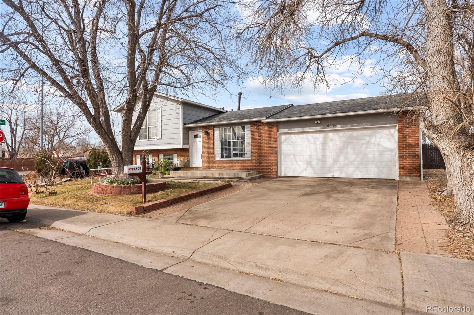 4609 Fontana Way Denver, CO 80239 - Photo 1 of 22 a view of a house with snow on the road
