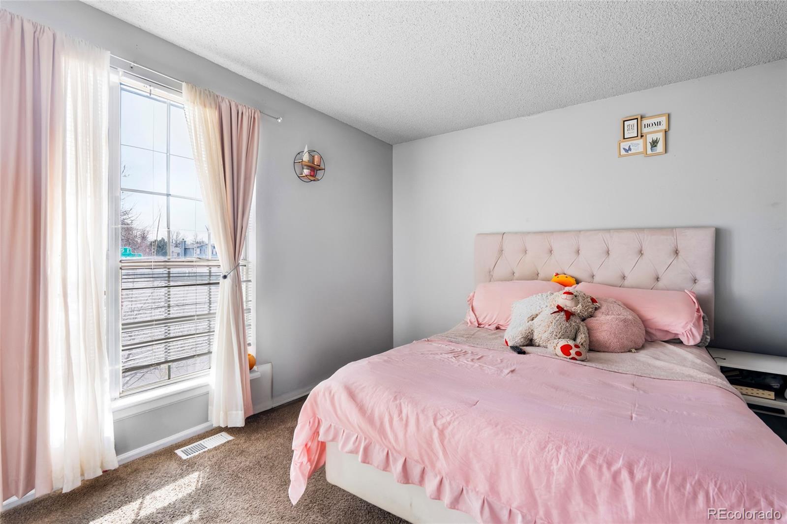 4609 Fontana Way Denver, CO 80239 - Photo 11 of 22 a bedroom with a large bed and a window
