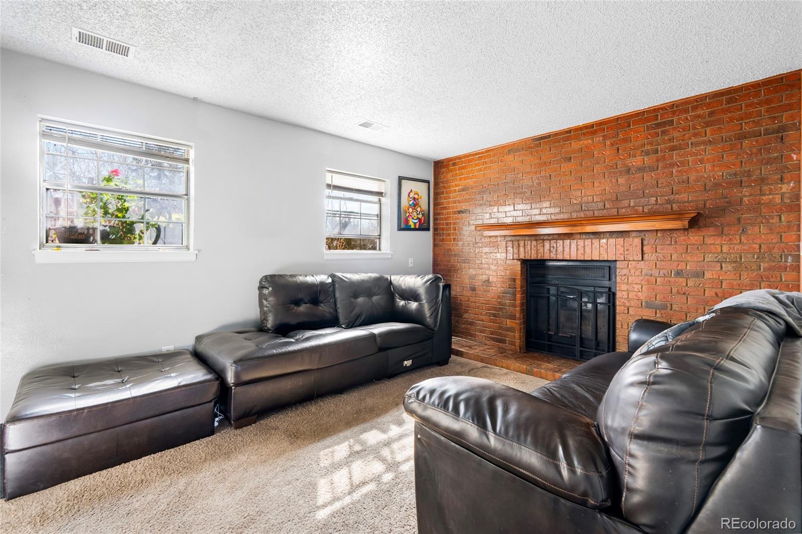 4609 Fontana Way Denver, CO 80239 - Photo 14 of 22 a living room with furniture and a fireplace
