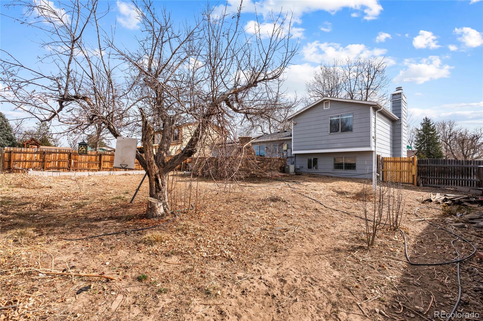 4609 Fontana Way Denver, CO 80239 - Photo 19 of 22 a front view of a house with a yard covered in snow