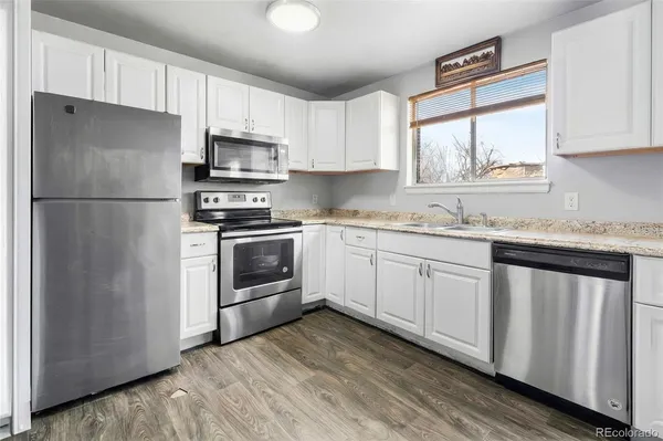 a kitchen with a white cabinets and white appliances