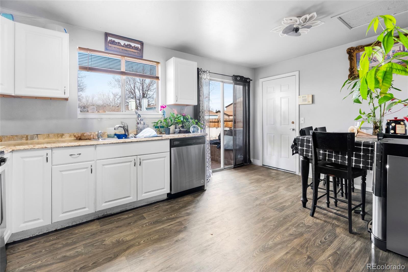 4609 Fontana Way Denver, CO 80239 - Photo 8 of 22 a kitchen with a table and chairs in it