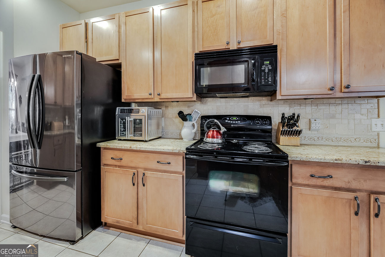 150 Royal Lane Pooler, GA 31322 - Photo 15 of 38 a kitchen with stainless steel appliances granite countertop a refrigerator stove and microwave