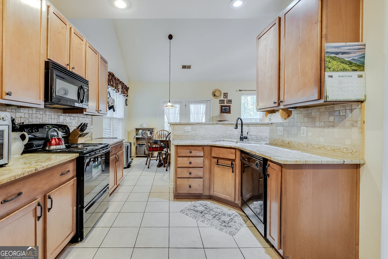 150 Royal Lane Pooler, GA 31322 - Photo 17 of 38 a kitchen with stainless steel appliances granite countertop a sink and a stove