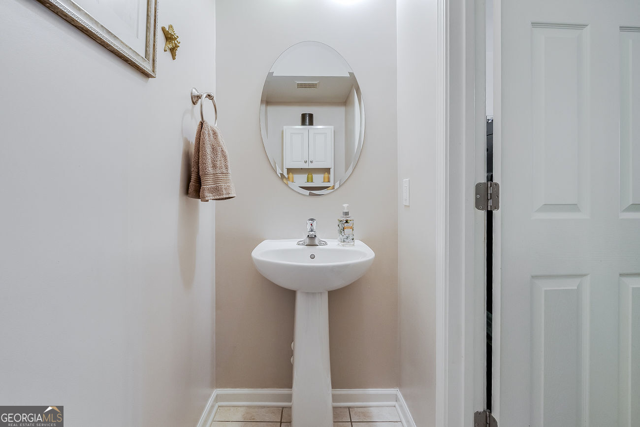 150 Royal Lane Pooler, GA 31322 - Photo 19 of 38 a bathroom with a sink and a mirror