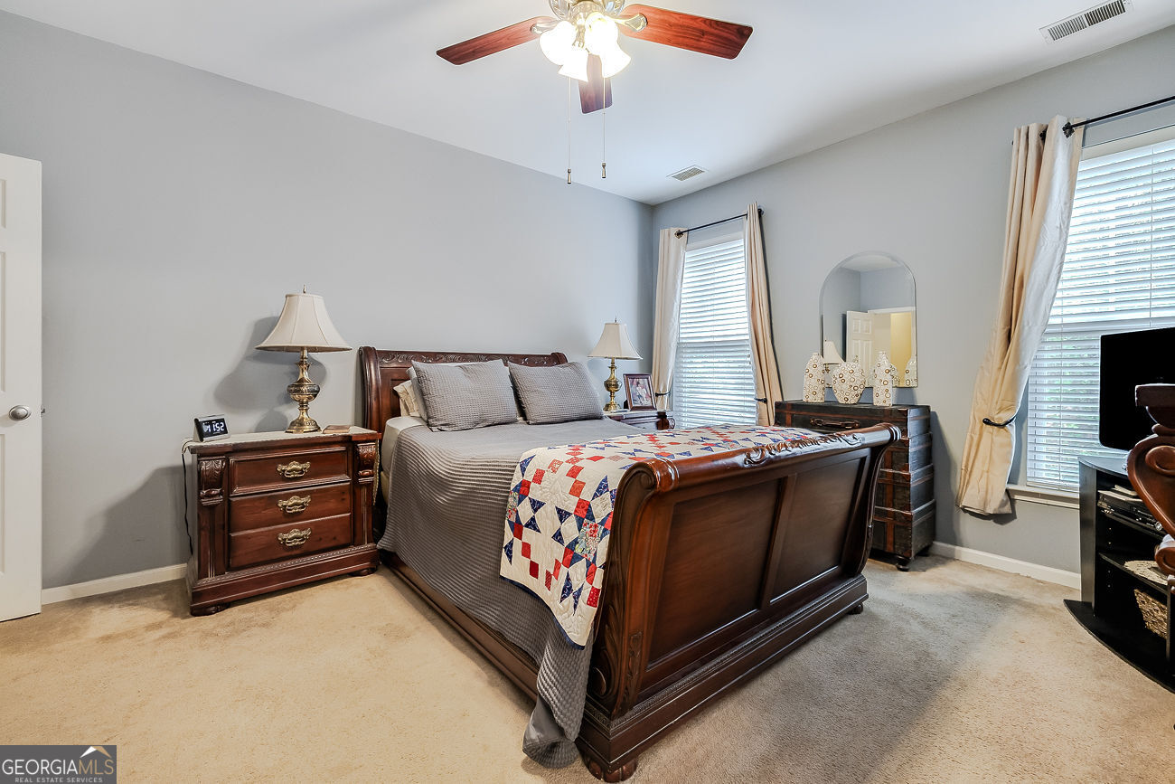 150 Royal Lane Pooler, GA 31322 - Photo 20 of 38 a bedroom with a bed and a chandelier