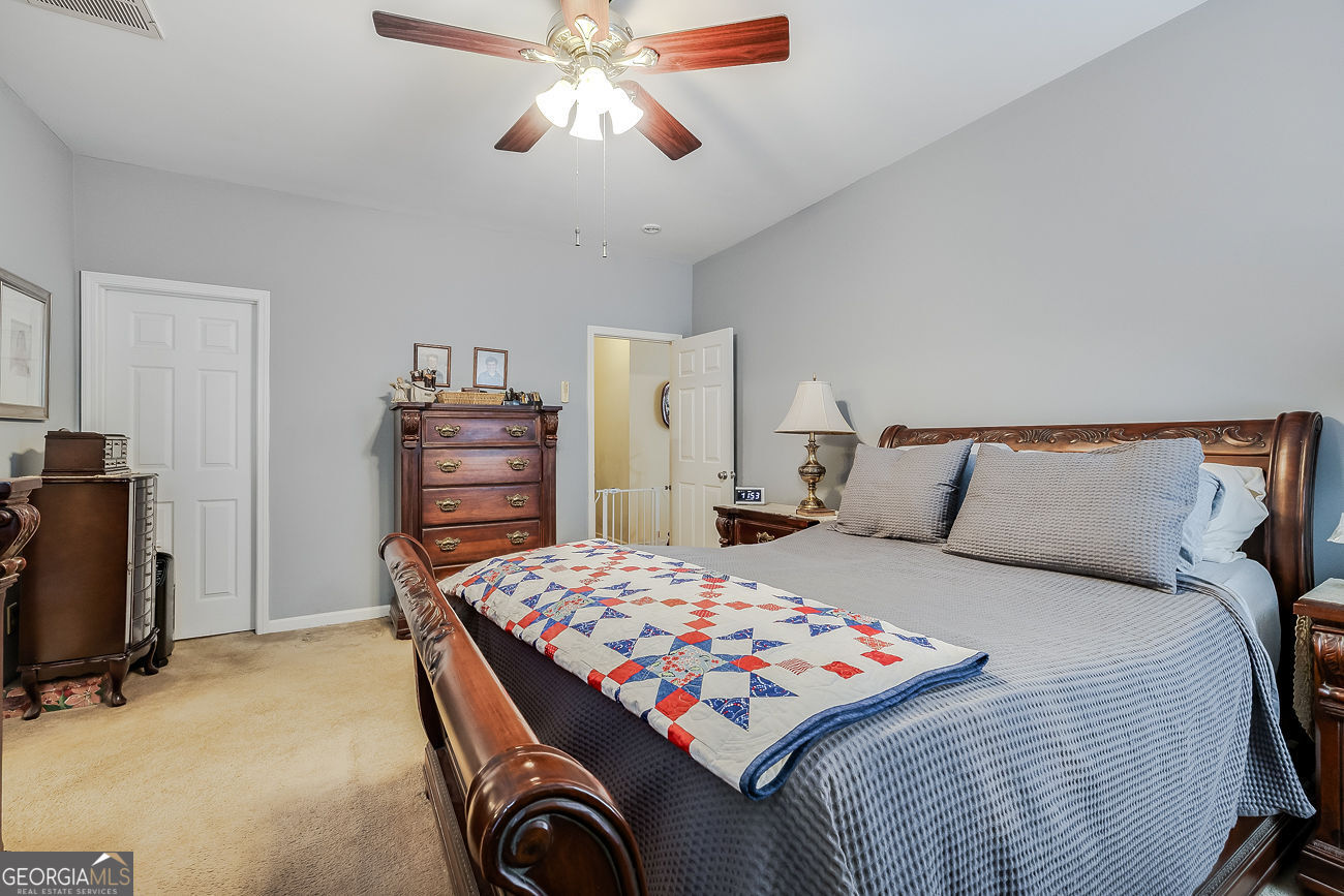 150 Royal Lane Pooler, GA 31322 - Photo 21 of 38 a bedroom with a bed and wooden floor