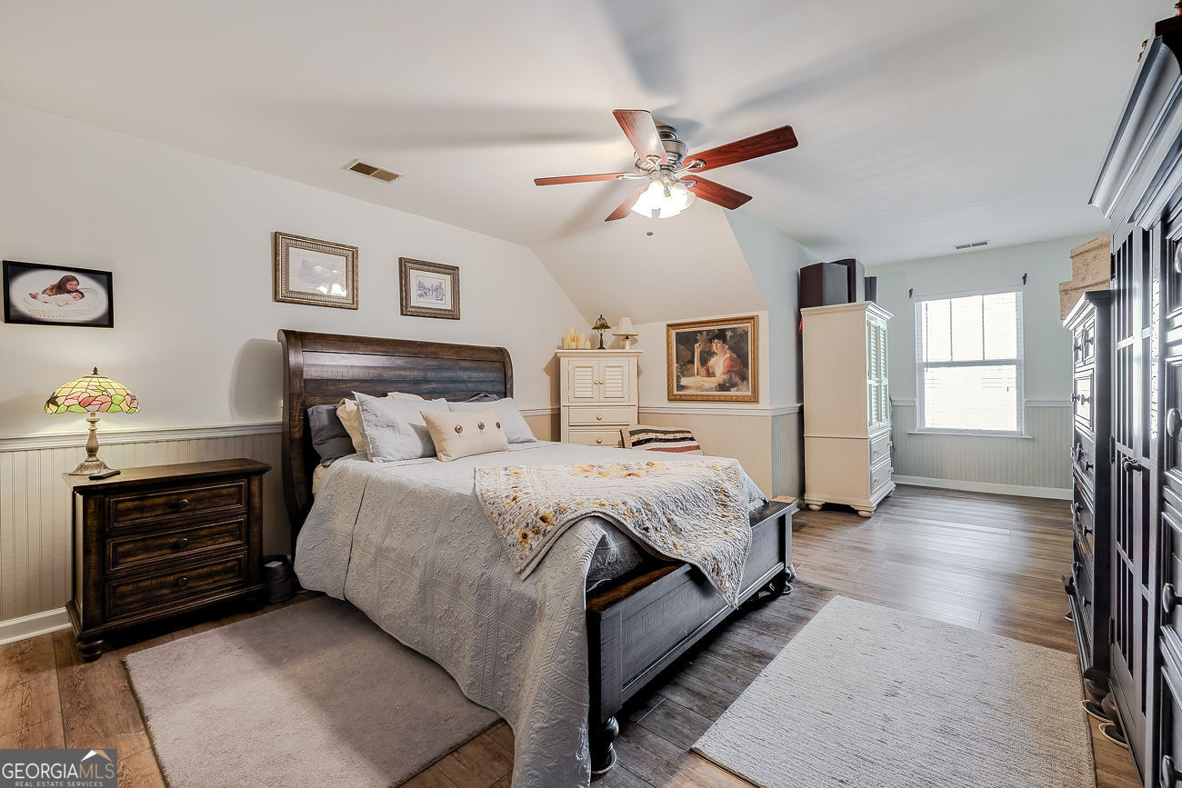150 Royal Lane Pooler, GA 31322 - Photo 29 of 38 a spacious bedroom with a bed and a chandelier