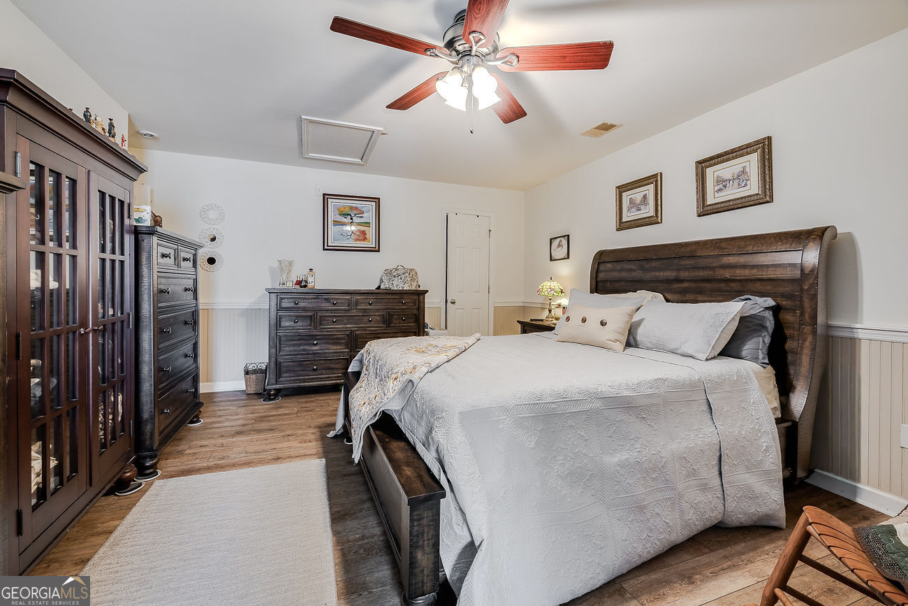 150 Royal Lane Pooler, GA 31322 - Photo 31 of 38 a bedroom with a bed and wooden floor