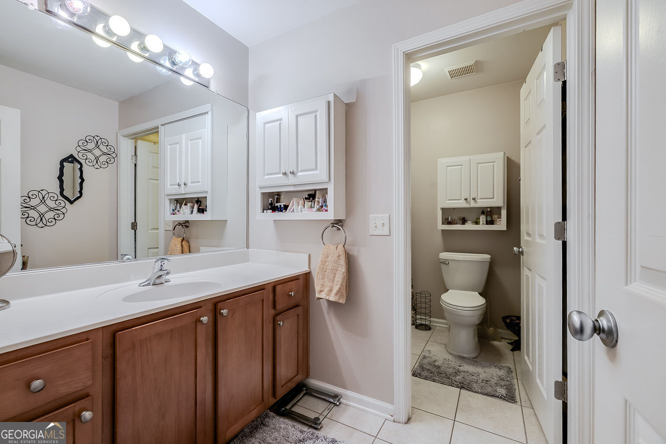 150 Royal Lane Pooler, GA 31322 - Photo 32 of 38 a spacious bathroom with a granite countertop sink toilet and shower