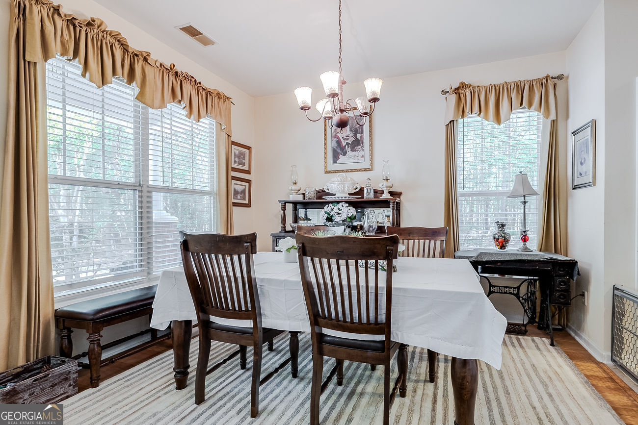 150 Royal Lane Pooler, GA 31322 - Photo 7 of 38 a view of a dining room with furniture window and wooden floor