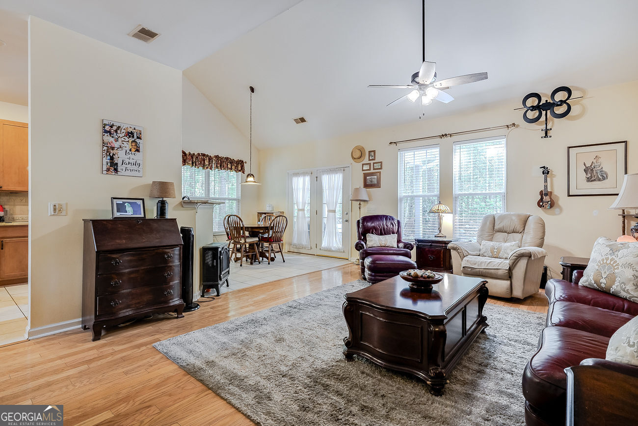 150 Royal Lane Pooler, GA 31322 - Photo 10 of 38 a living room with furniture a dining table and a fireplace