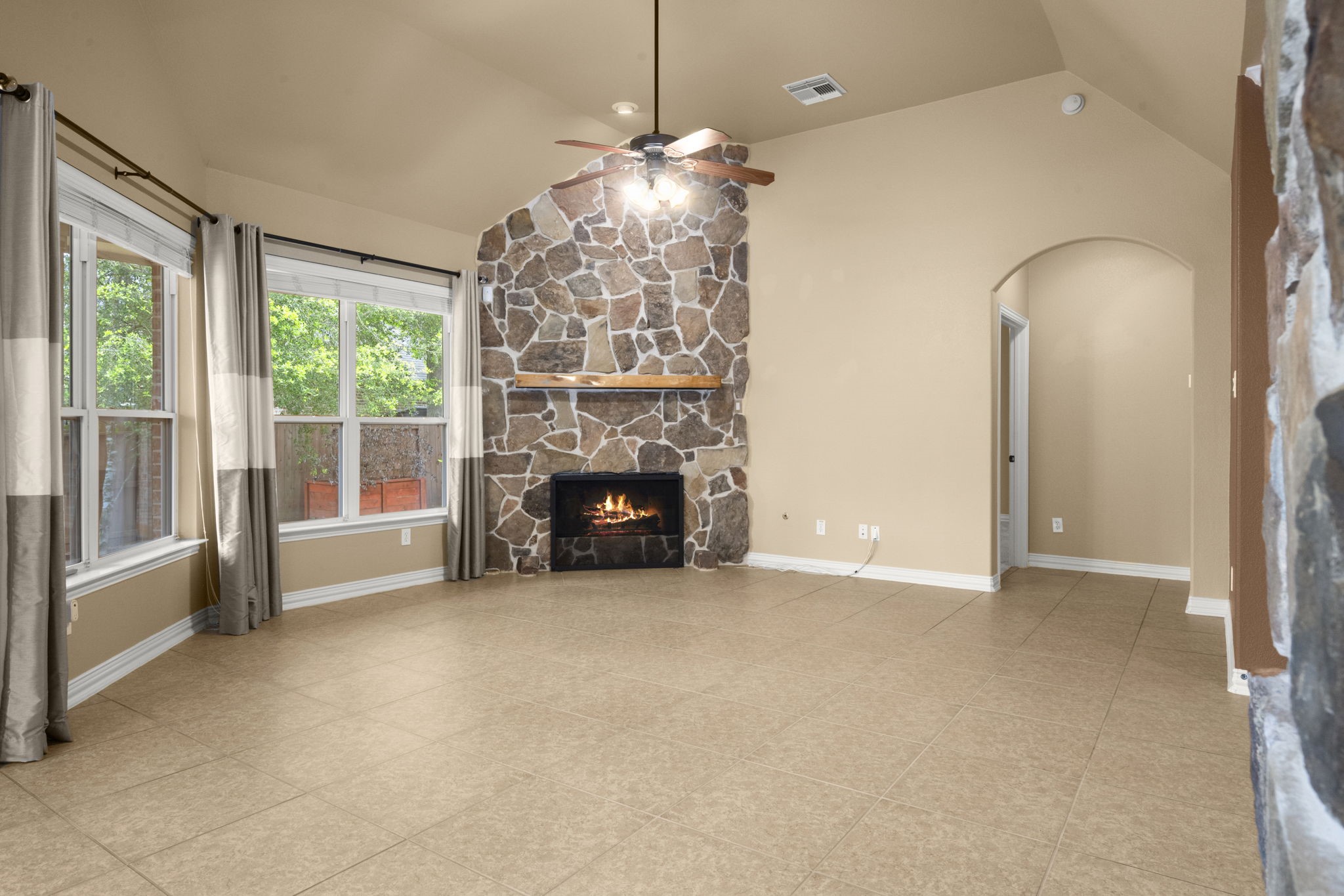 110 David Forest Lane Conroe, TX 77384 - Photo 22 of 35 an empty room with windows fireplace and chandelier