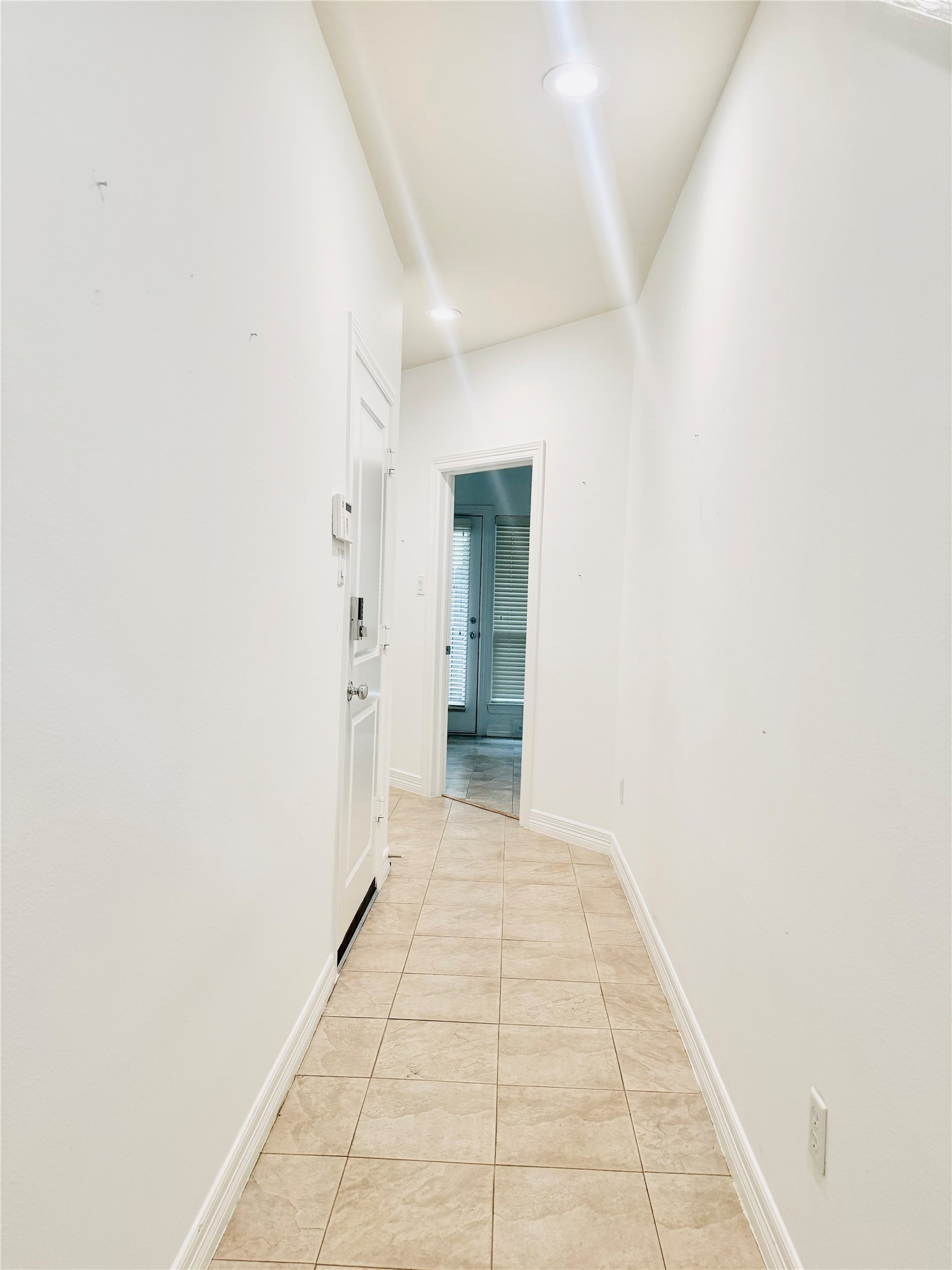 3846 Center Street Houston, TX 77007 - Photo 5 of 37 A bright, hallway with tiled flooring leads to the rooms.