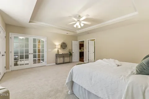 a spacious bedroom with a large bed and a window