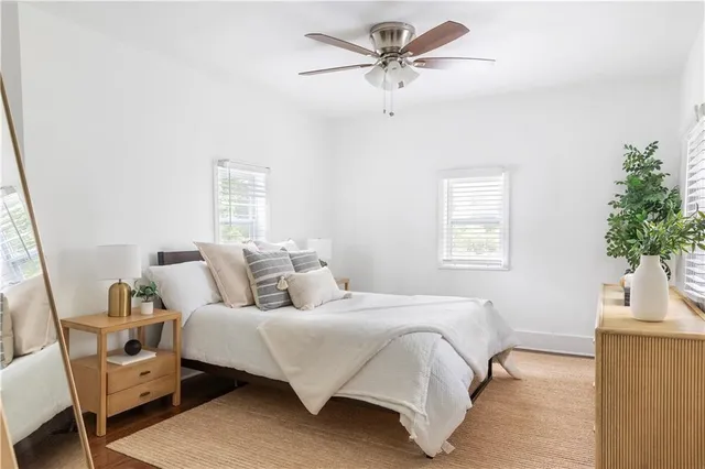 a bedroom with a bed a chandelier and a window