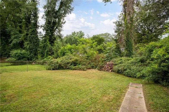 a view of yard with swimming pool and green space