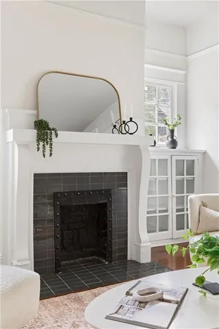 a living room with a fireplace and a rug